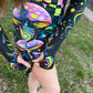 Rainbow Portal Hooded Rave Romper by Drip Drop Labs featuring a colorful, psychedelic design with a hood and festival-ready style.