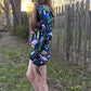 Rainbow Portal Hooded Rave Romper by Drip Drop Labs featuring a psychedelic rainbow design and hood, perfect for festival wear.