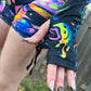 Rainbow Portal Hooded Rave Romper by Drip Drop Labs featuring a colorful psychedelic design and hood, perfect for festival wear.