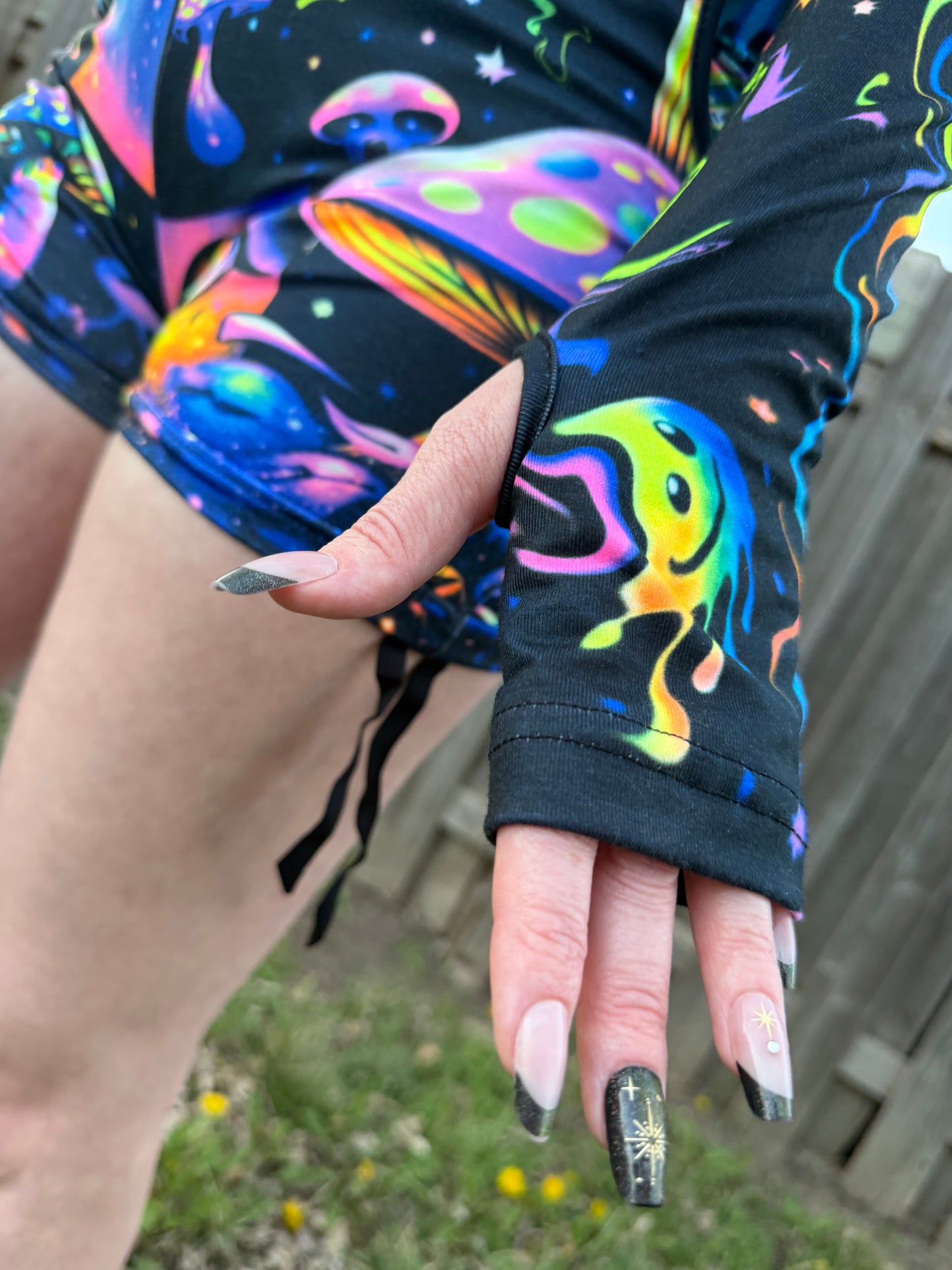 Rainbow Portal Hooded Rave Romper by Drip Drop Labs featuring a colorful psychedelic design and hood, perfect for festival wear.