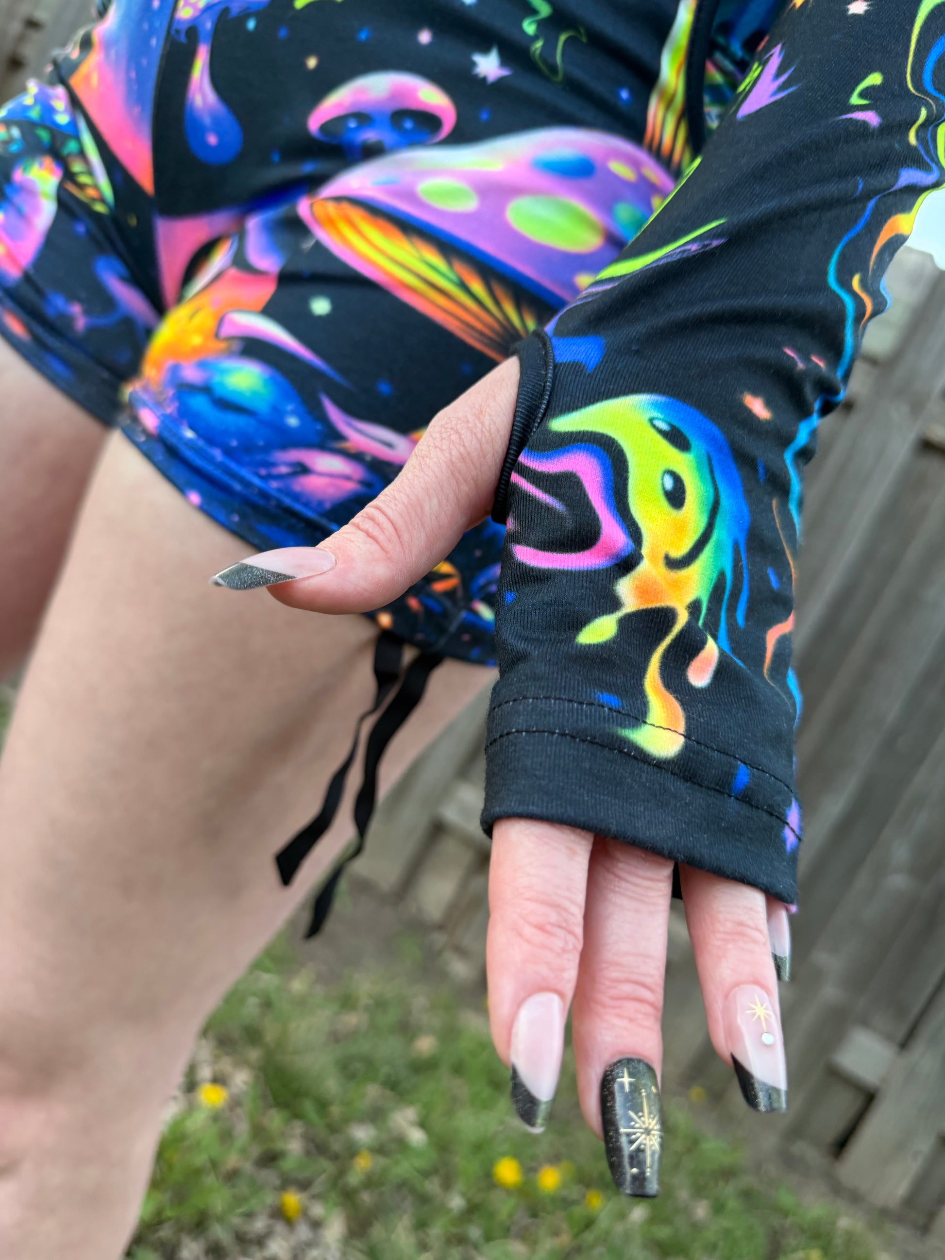 Rainbow Portal Hooded Rave Romper by Drip Drop Labs featuring a colorful psychedelic design and hood, perfect for festival wear.