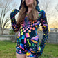 Rainbow Portal Hooded Rave Romper by Drip Drop Labs featuring a psychedelic rainbow design and hood, perfect for festival wear.