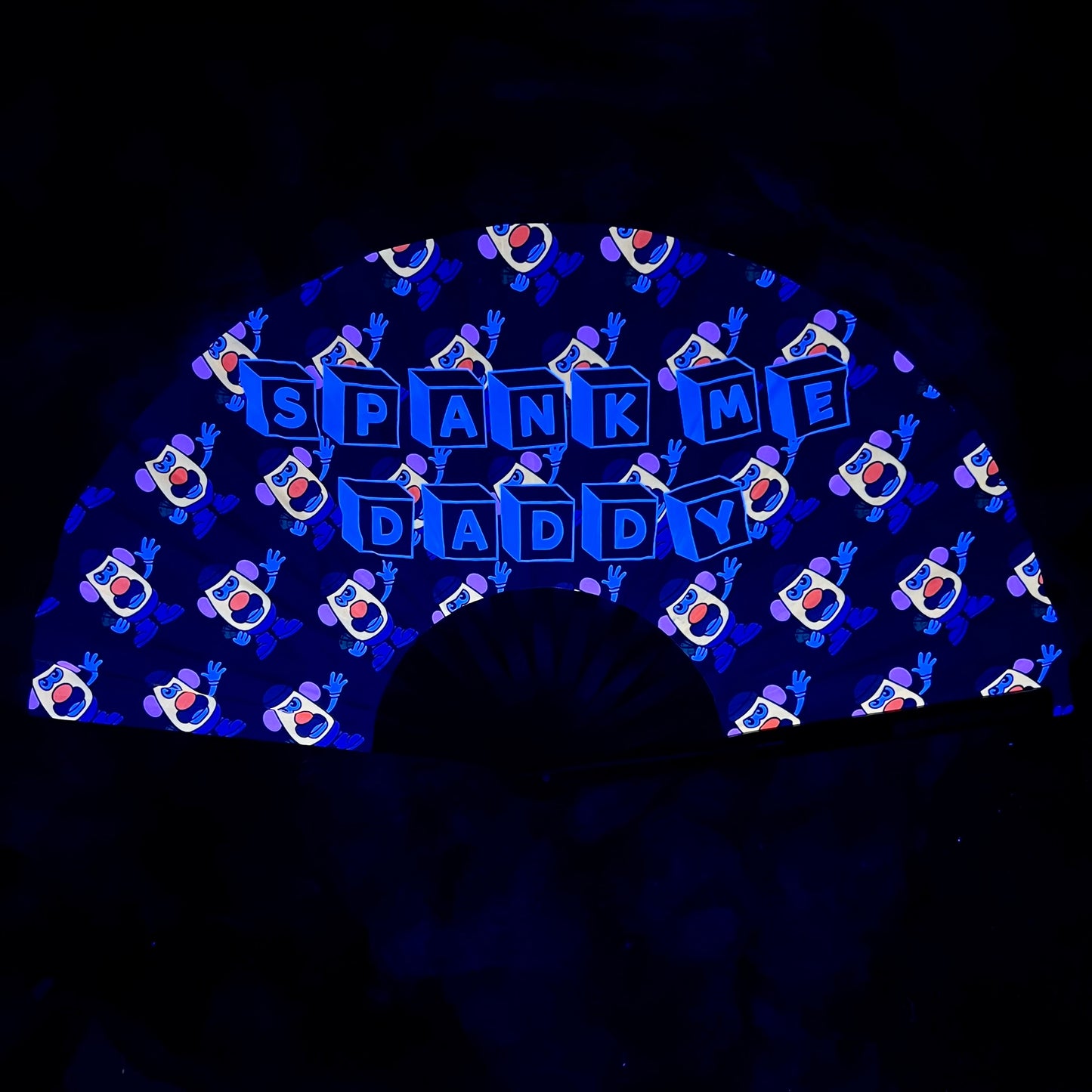 Drip Drop Labs Spank Me Glow Fan, a handheld fan with glowing design, ideal for festivals and outdoor events.