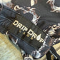 Dark galactic hooded rave romper by Drip Drop Labs, featuring vibrant cosmic patterns and a comfortable festival fit.