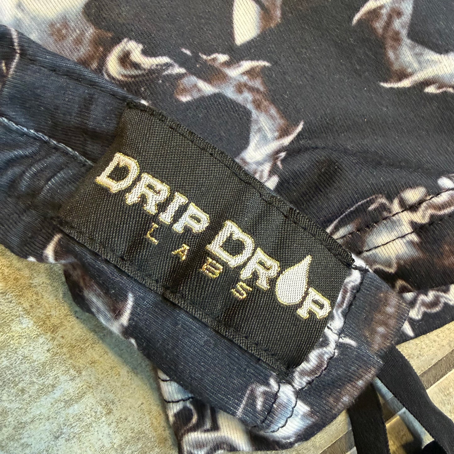 Dark galactic hooded rave romper by Drip Drop Labs, featuring vibrant cosmic patterns and a comfortable festival fit.