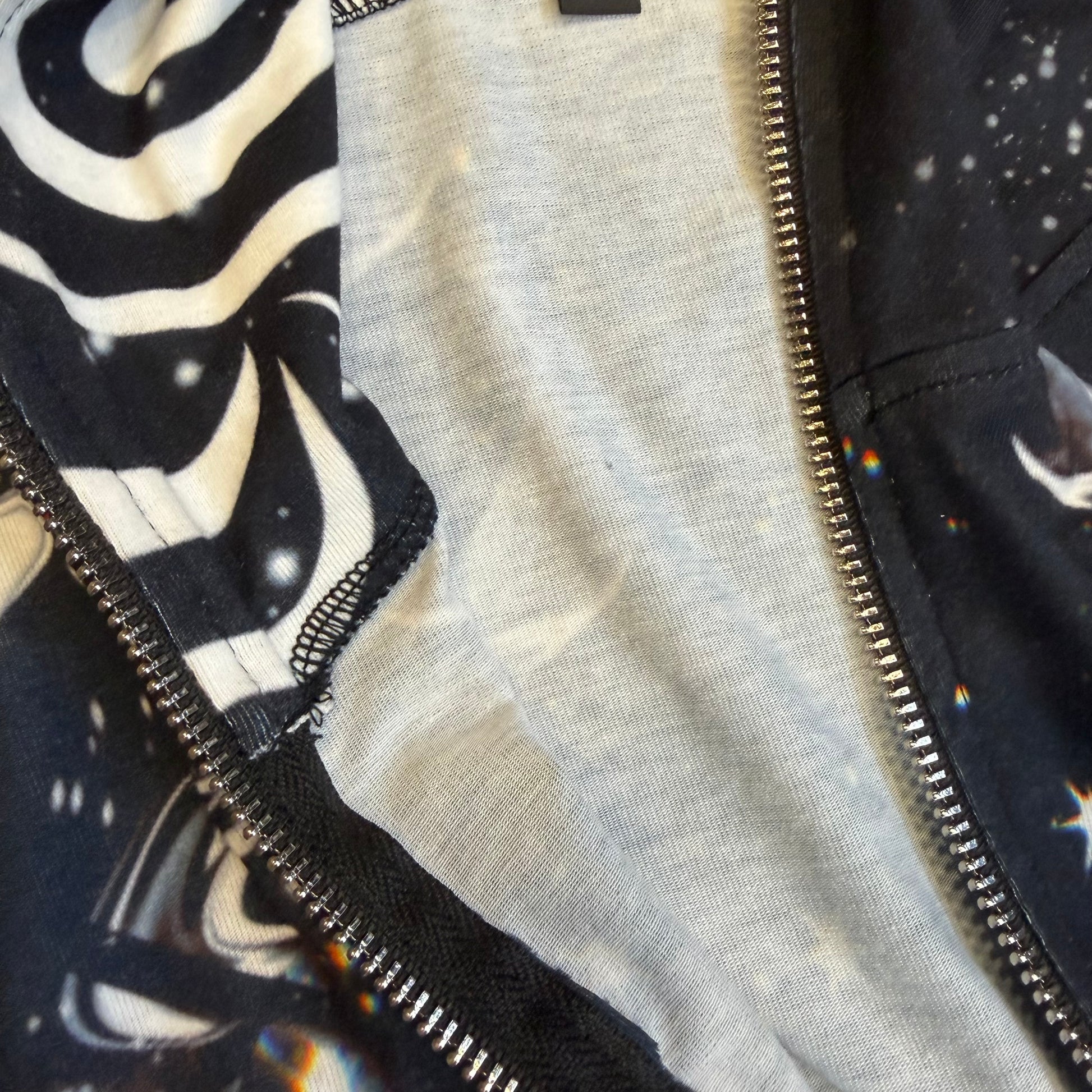 Dark galactic themed hooded rave romper by Drip Drop Labs featuring a cosmic print and festival style for vibrant dance events.