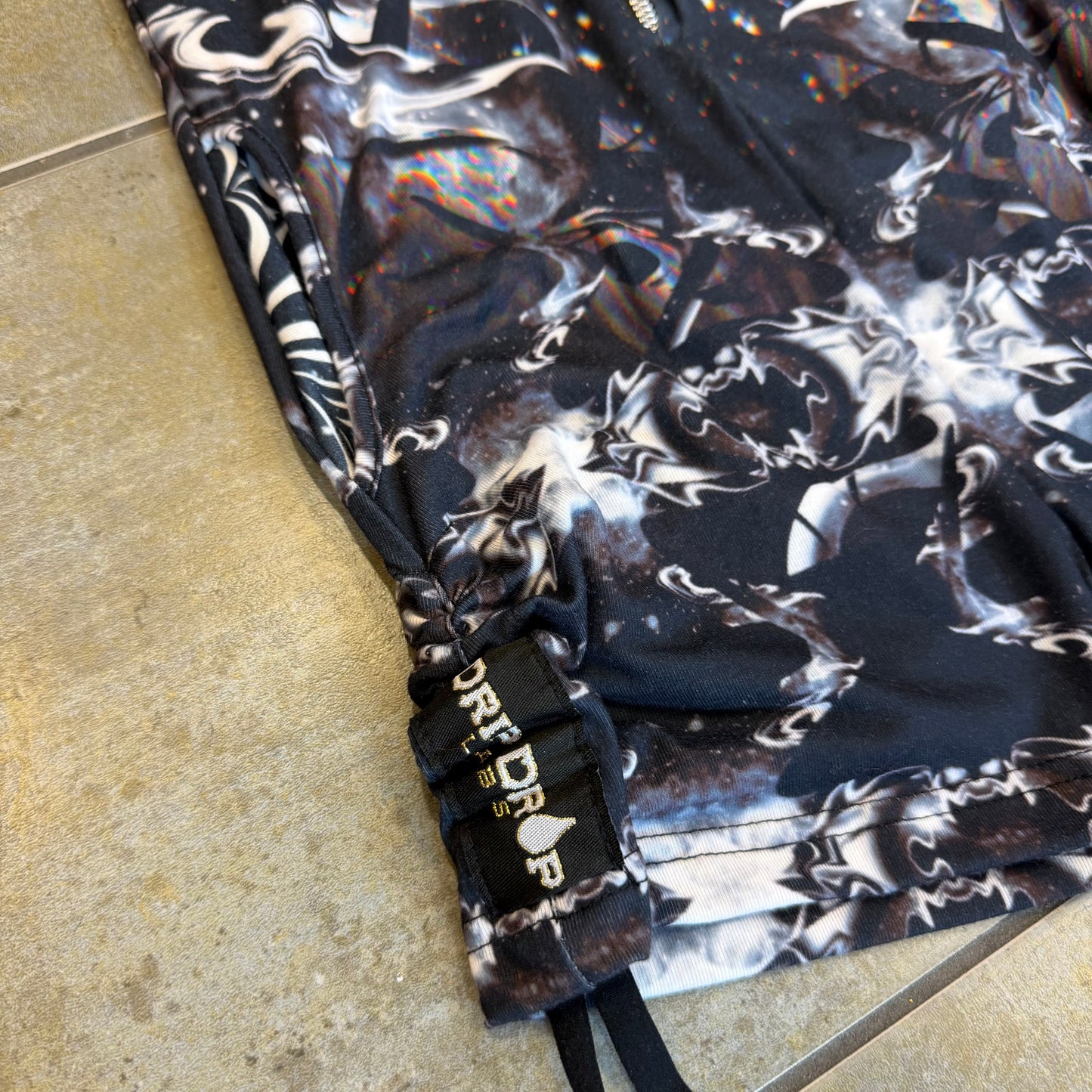 Dark galactic-themed hooded rave romper by Drip Drop Labs, featuring a space-inspired design and festival fit.