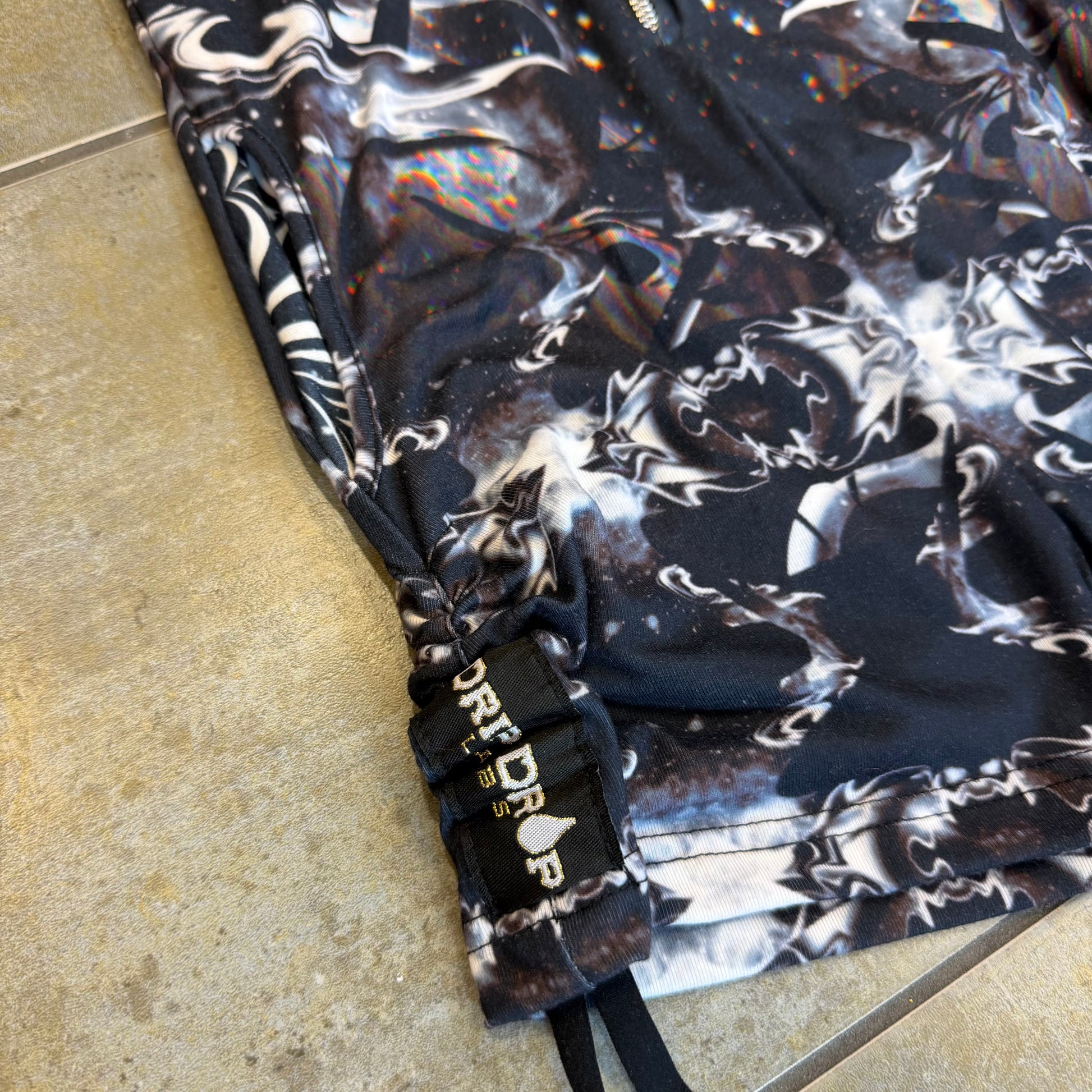 Dark galactic-themed hooded rave romper by Drip Drop Labs, featuring a space-inspired design and festival fit.