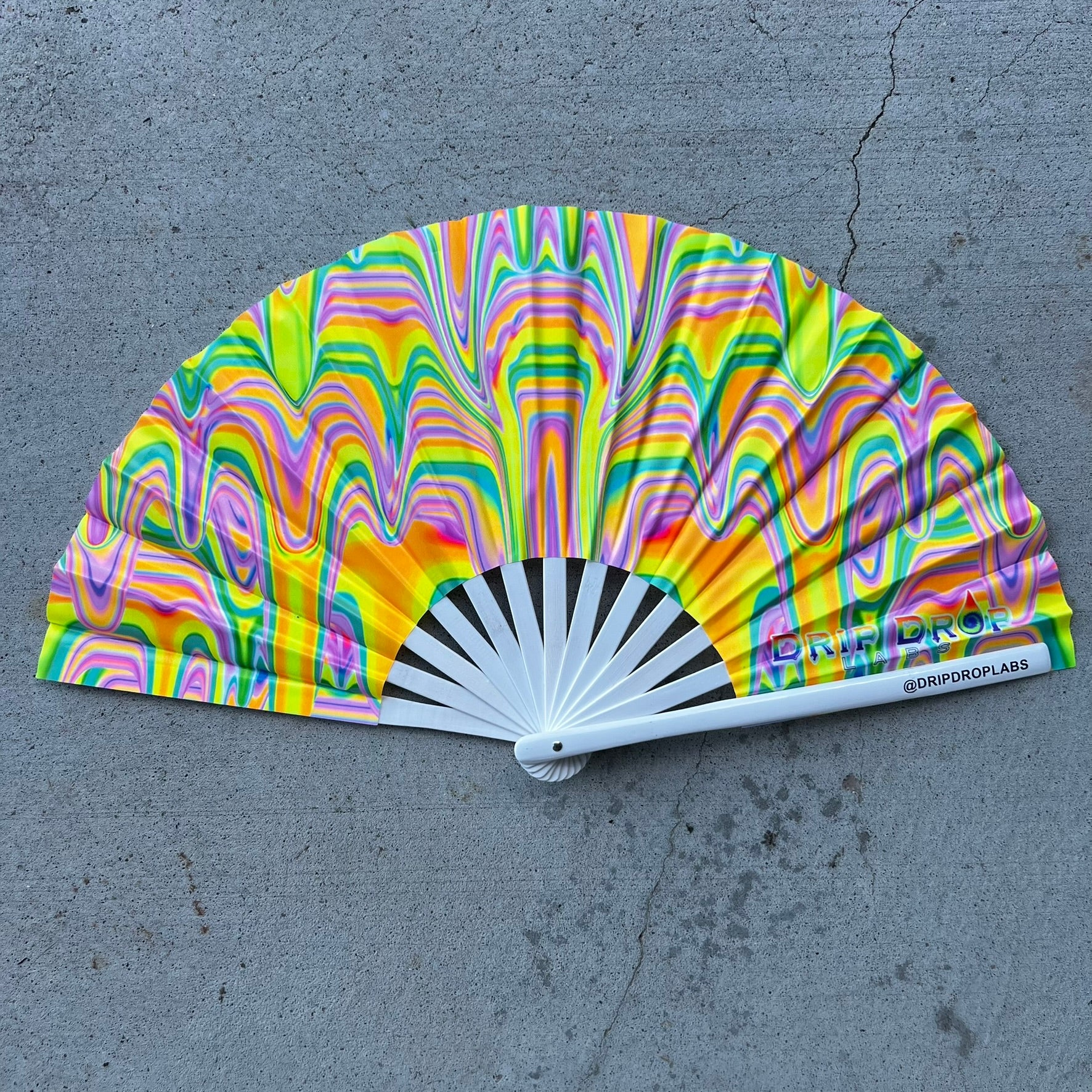 Drip Drop Labs Sunrise Drip Glow Fan displaying a colorful, illuminated fan with vibrant glow effects in a dark setting.