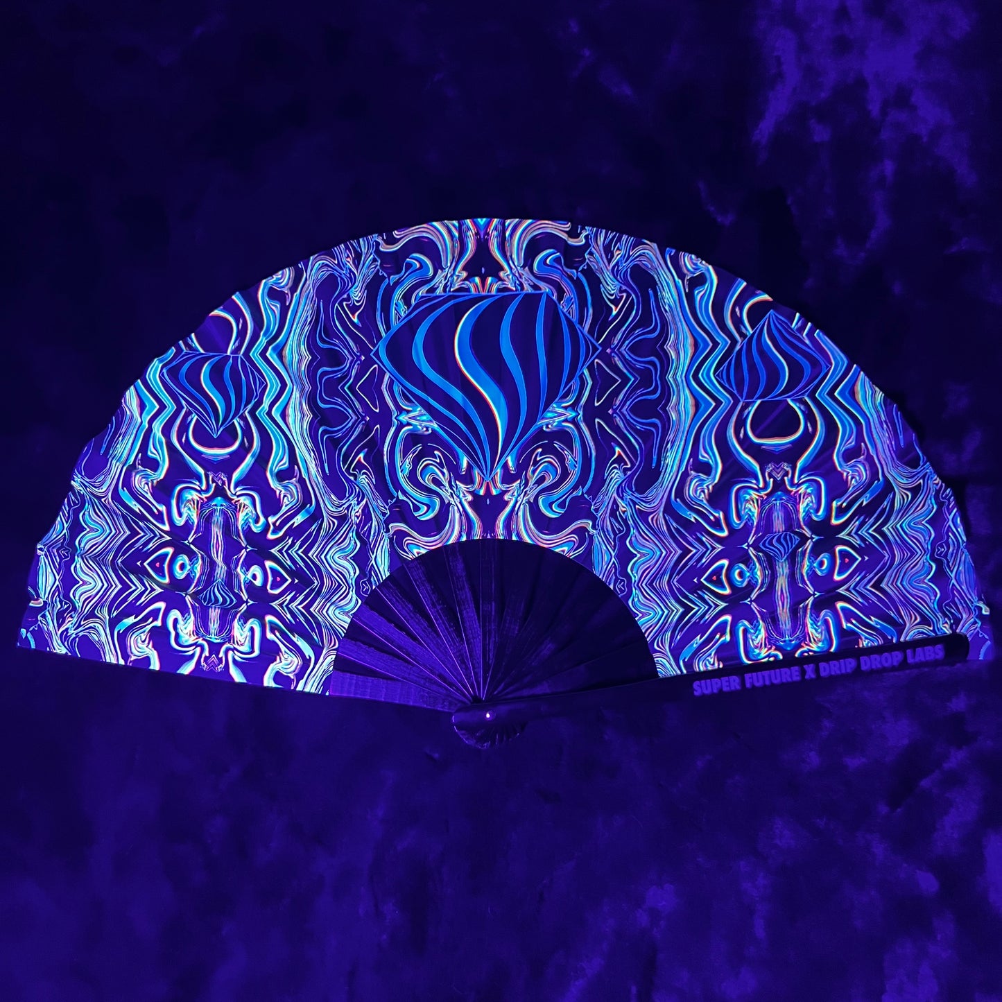 Drip Drop Labs Super Future Glow Fan displaying illuminated blades with vibrant glow effects in a dark setting.