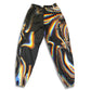 Drip Drop Labs Super Future parachute pants in lightweight, loose-fitting fabric with adjustable drawstrings and oversized pockets.
