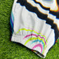 White parachute pants from Drip Drop Labs' Super Future collection, featuring a relaxed fit and adjustable waistband.