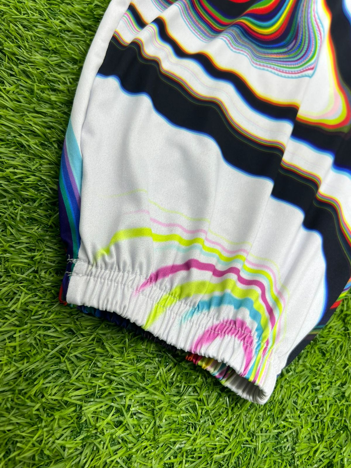 White parachute pants from Drip Drop Labs' Super Future collection, featuring a relaxed fit and adjustable waistband.