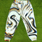 White parachute pants by Drip Drop Labs featuring a loose fit, adjustable drawstrings, and modern streetwear style.