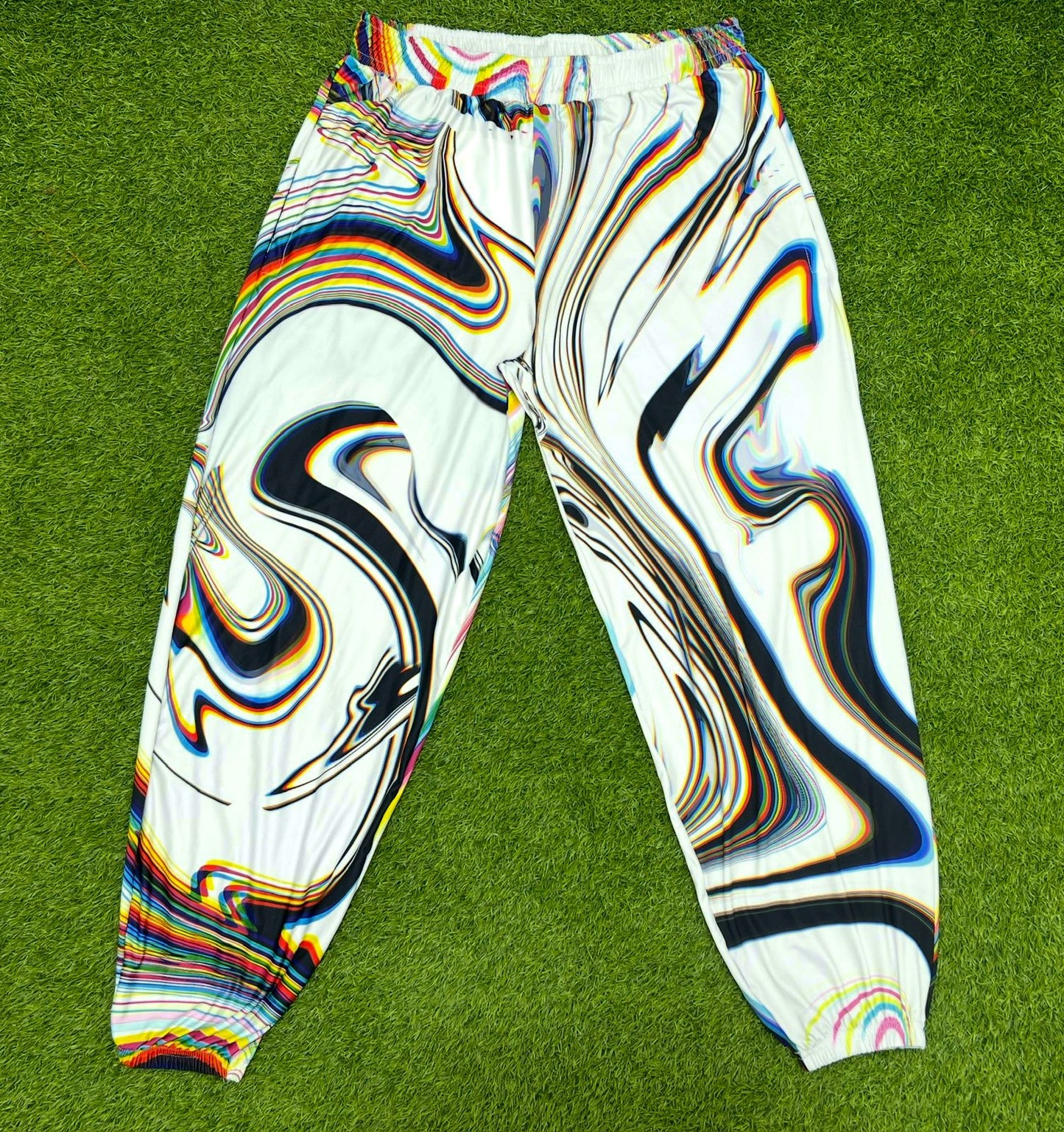 White parachute pants by Drip Drop Labs featuring a loose fit, adjustable drawstrings, and modern streetwear style.