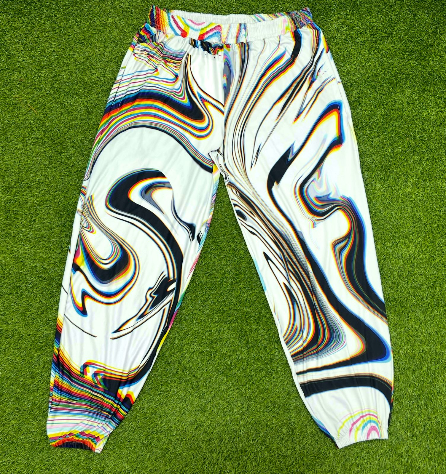 White parachute pants by Drip Drop Labs featuring a loose fit, adjustable drawstrings, and modern streetwear style.