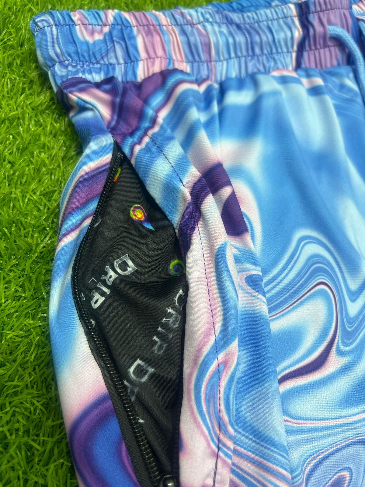 Drip Drop Labs Waves parachute pants in lightweight fabric with a relaxed fit and wave pattern design.