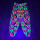 Drip Drop Labs Wild Forest parachute pants in green camouflage fabric with relaxed fit and drawstring waist.
