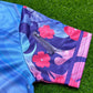 Drip Drop Labs Zodiac Flower hooded baseball jersey featuring colorful floral design and casual sporty style.