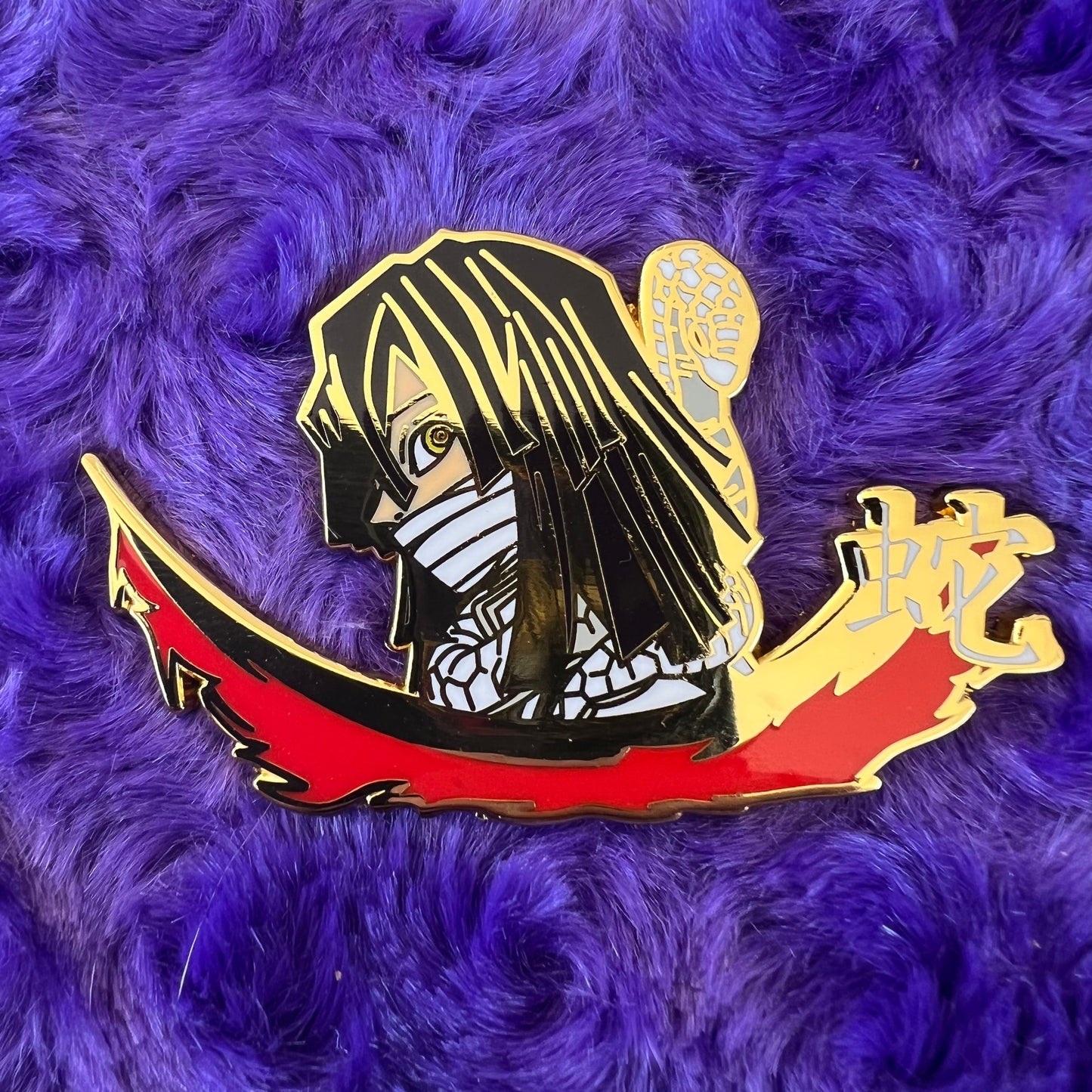 Kingdesigns26 serpent pin featuring a detailed, metallic serpent design on a decorative pin back.
