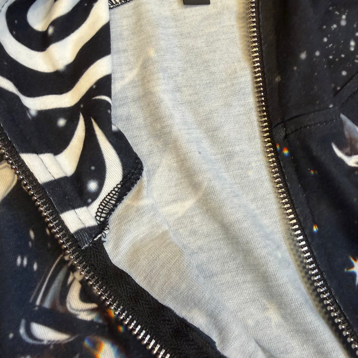 Dark galactic themed hooded rave romper by Drip Drop Labs featuring a cosmic print and festival style for vibrant dance events.