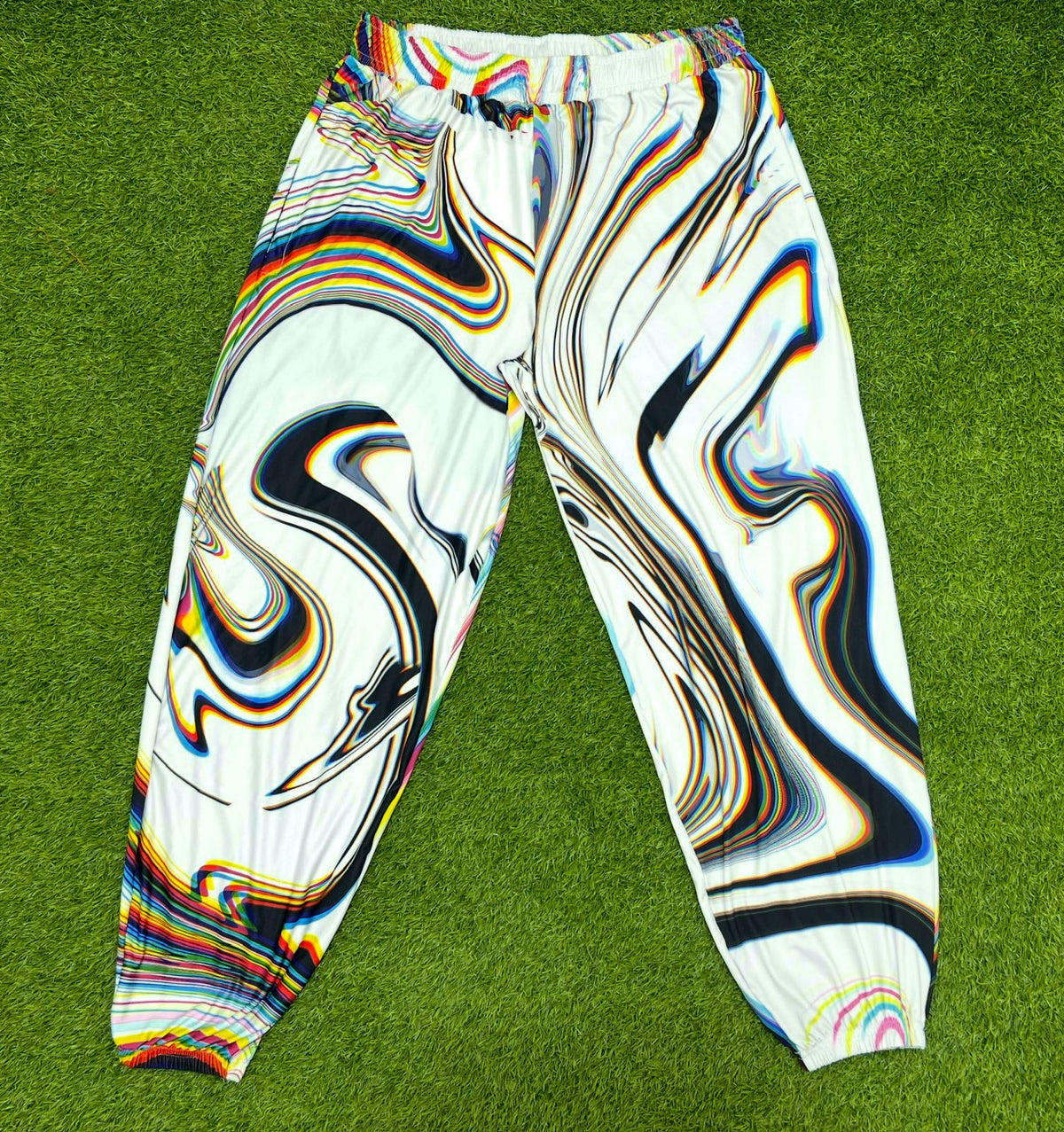 White parachute pants by Drip Drop Labs featuring a loose fit, adjustable drawstrings, and modern streetwear style.