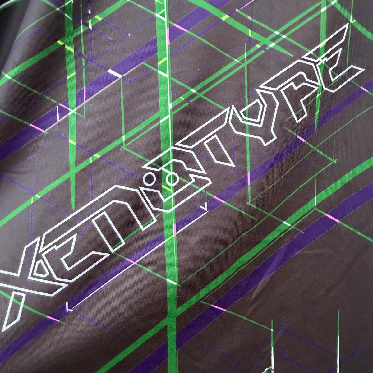 xenotype fabric texture close up with geometric patterns and logo