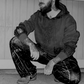 Model wearing a street tech hoodie and techwear xenotype pants