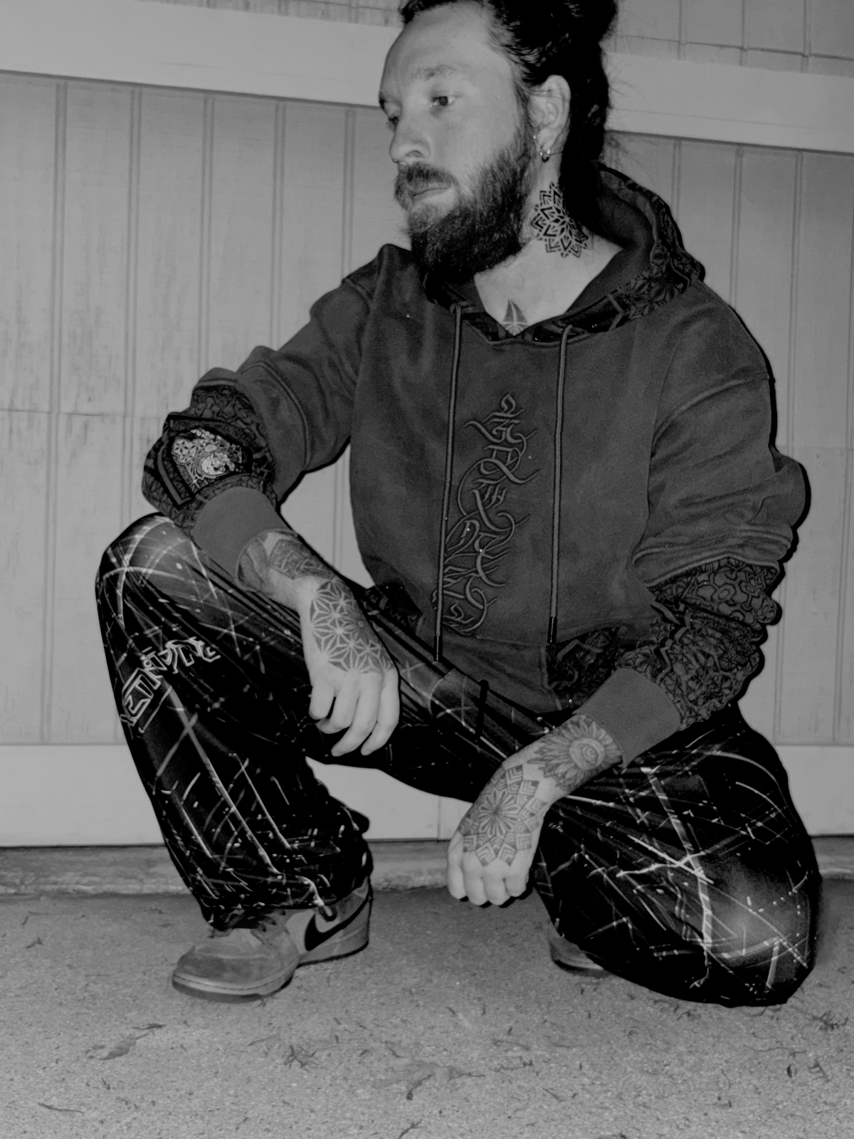 Model wearing a street tech hoodie and techwear xenotype pants