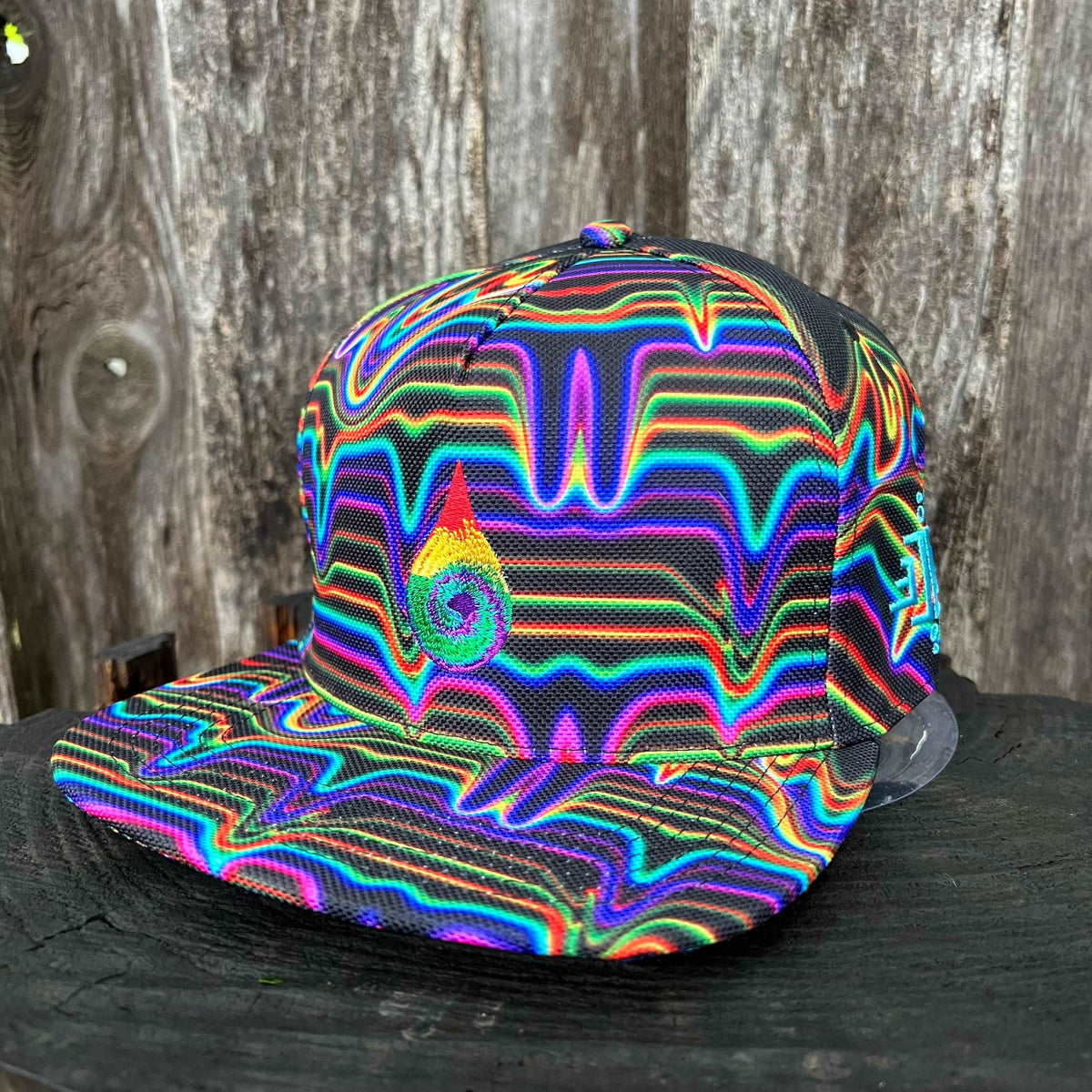 Black SnapBack hat by Drip Drop Labs with adjustable strap and embroidered logo, styled on a neutral background.