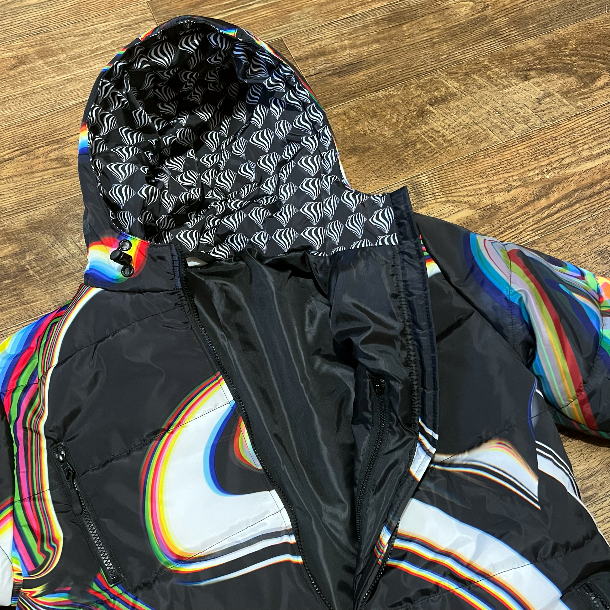 Black winter coat by Drip Drop Labs, featuring a sleek design and insulated fabric for cold weather warmth.
