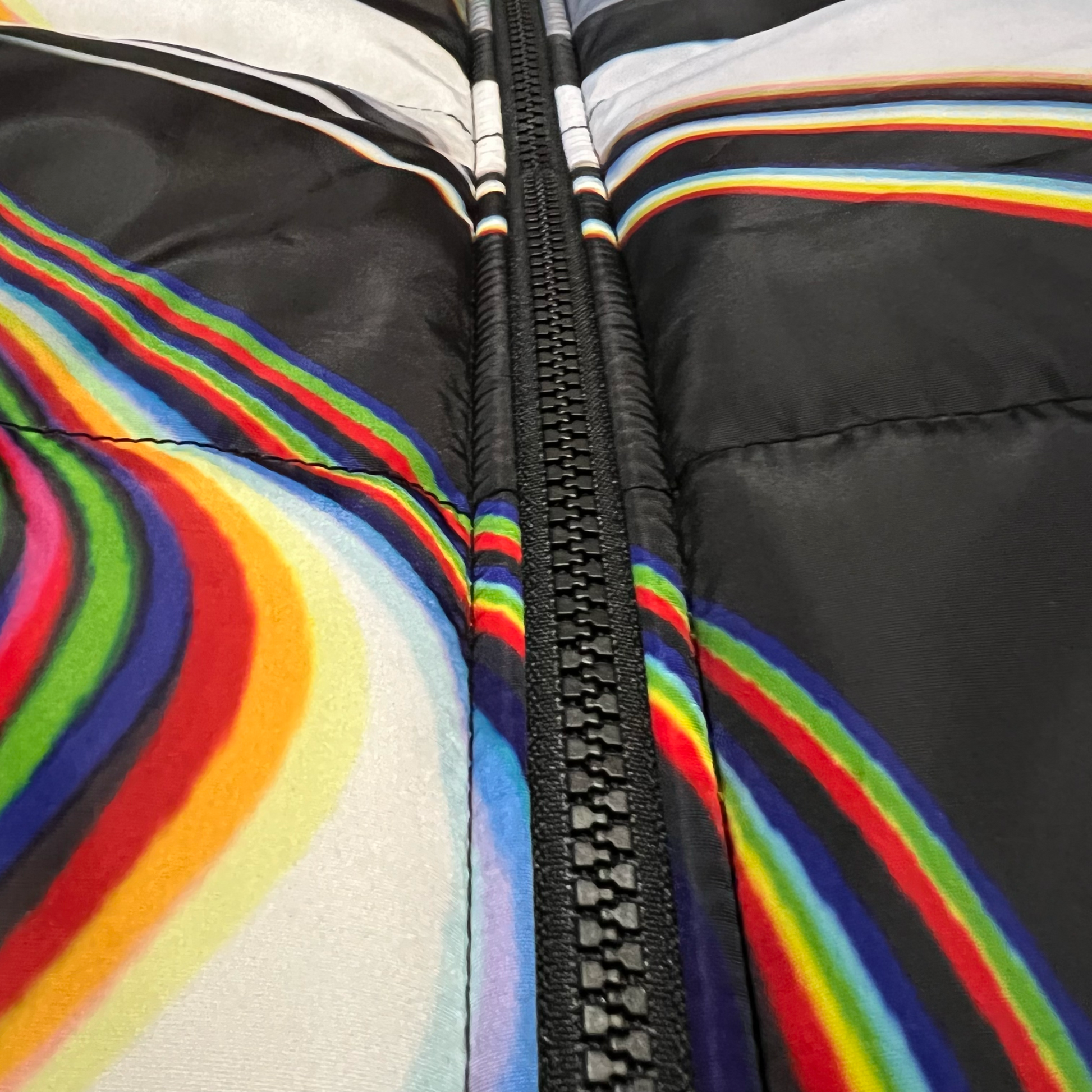 Drip Drop Labs Super Future black winter coat, cozy and stylish, shown on a hanger.