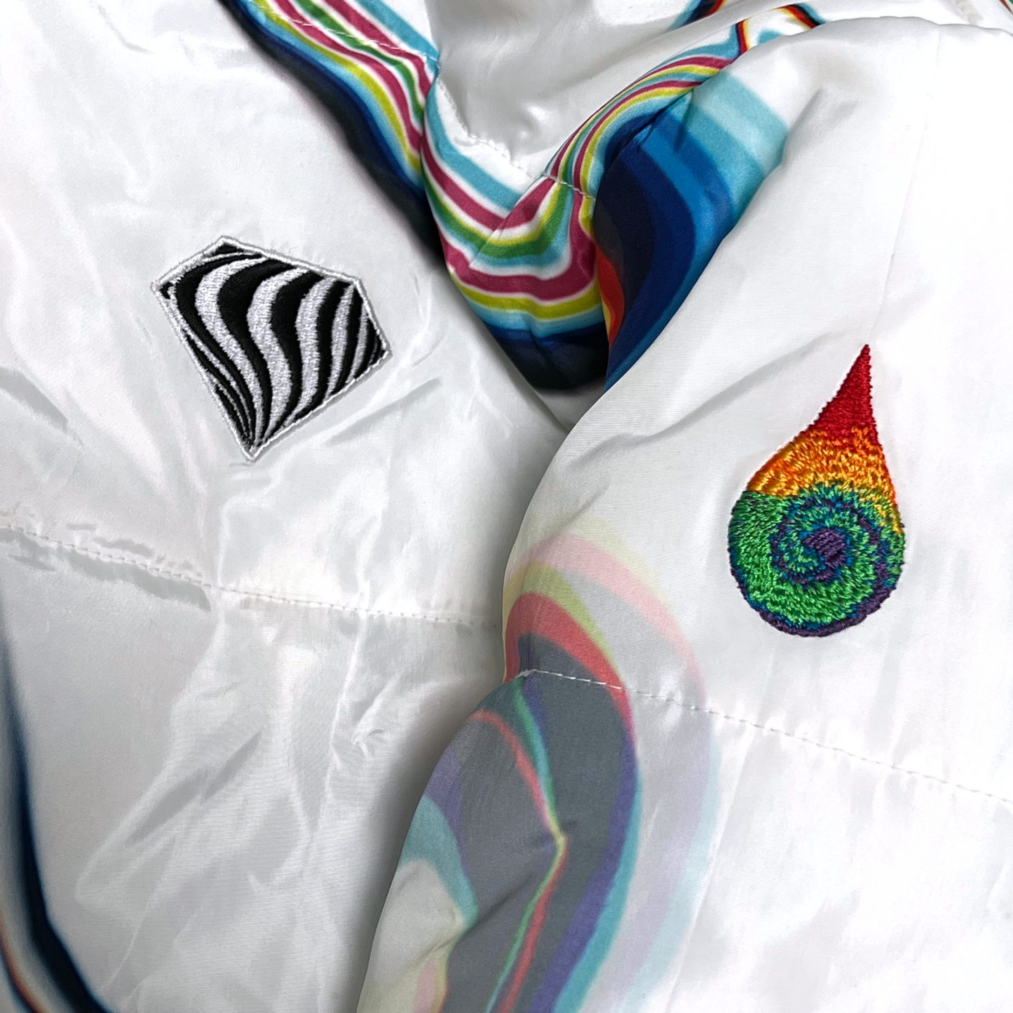 White winter coat by Drip Drop Labs, Super Future collection, showcasing a stylish, insulated coat with a high collar and sleek design.