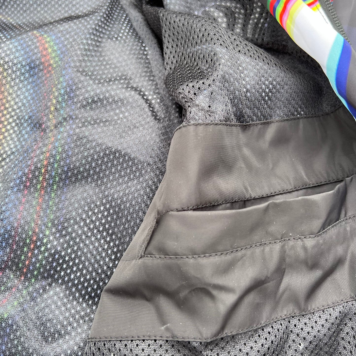 Black windbreaker jacket from Drip Drop Labs' Super Future collection, featuring a sleek design and lightweight material.