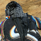 Drip Drop Labs Super Future black winter coat, showing front view with hood, zipper closure, and sleek winter style.