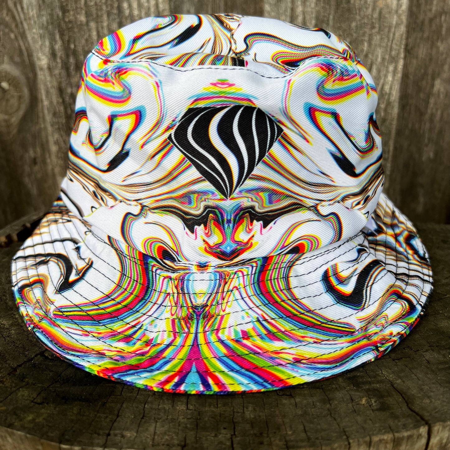 Reversible bucket hat by Drip Drop Labs featuring vibrant patterns and casual style, perfect for sun protection and fashion.