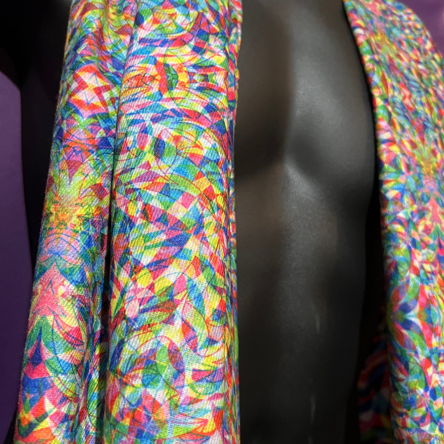 Drip Drop Labs Vibrationz Pashmina scarf featuring soft, luxurious fabric with a vibrant multicolor pattern, draped elegantly.