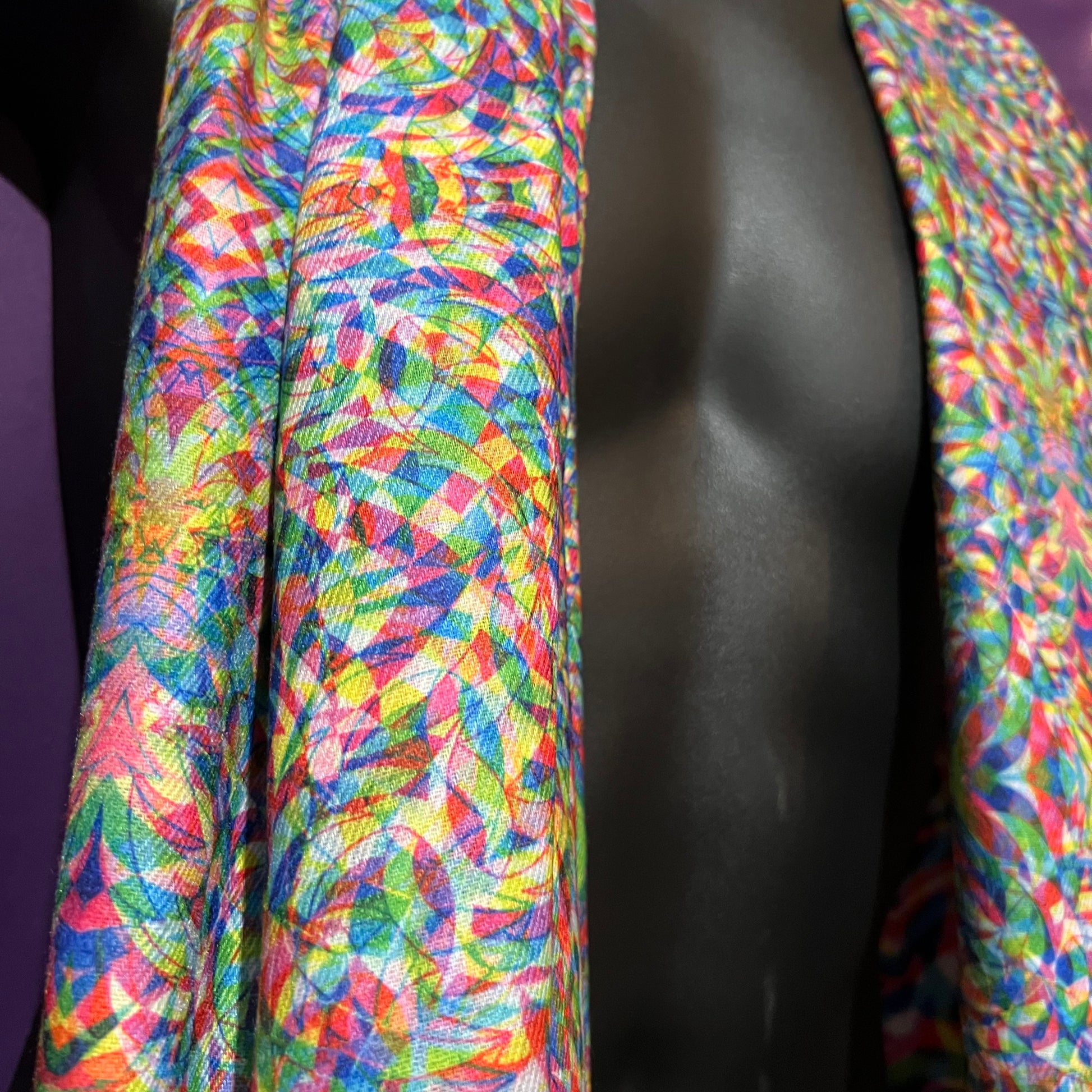 Drip Drop Labs Vibrationz Pashmina scarf featuring soft, luxurious fabric with a vibrant multicolor pattern, draped elegantly.